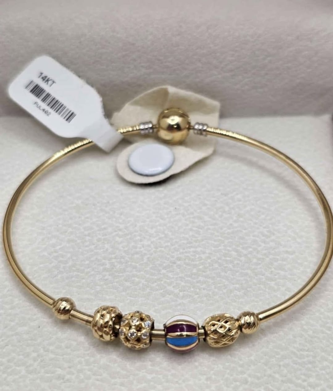 Rigid bracelet with charms